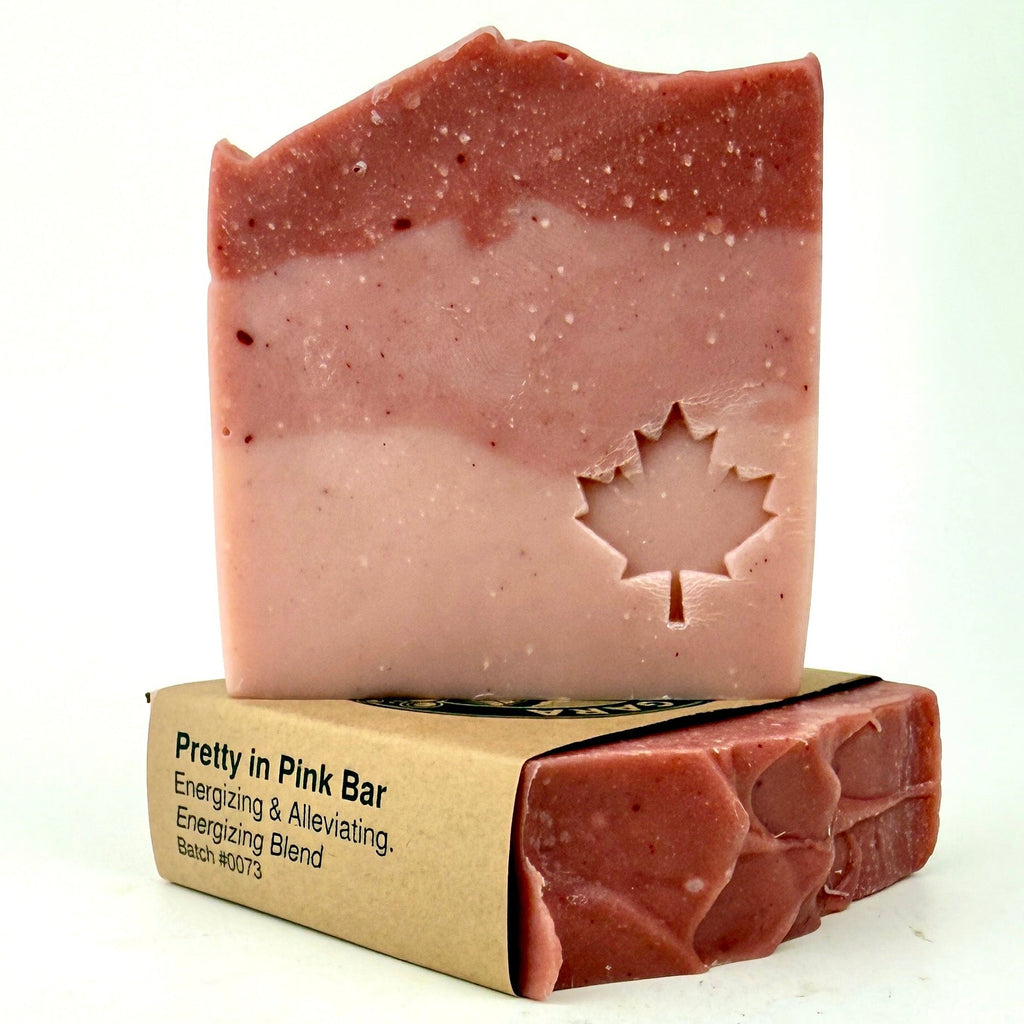 Pink soap bar with a leaf design on a white background