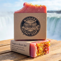 Two bars of Niagara Craft Soap on a wooden platform with a waterfall in the background