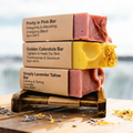 Stack of soap bars on a wooden stand with a blurred natural background