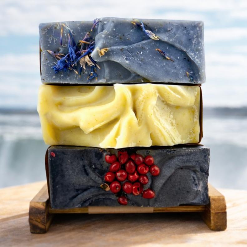 Three layered soap stack with natural elements on a wooden stand against a blurred natural background
