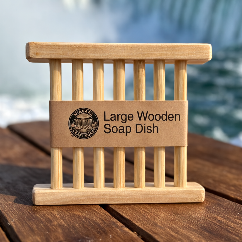 Large wooden soap dish on a wooden surface with a blurred waterfall background