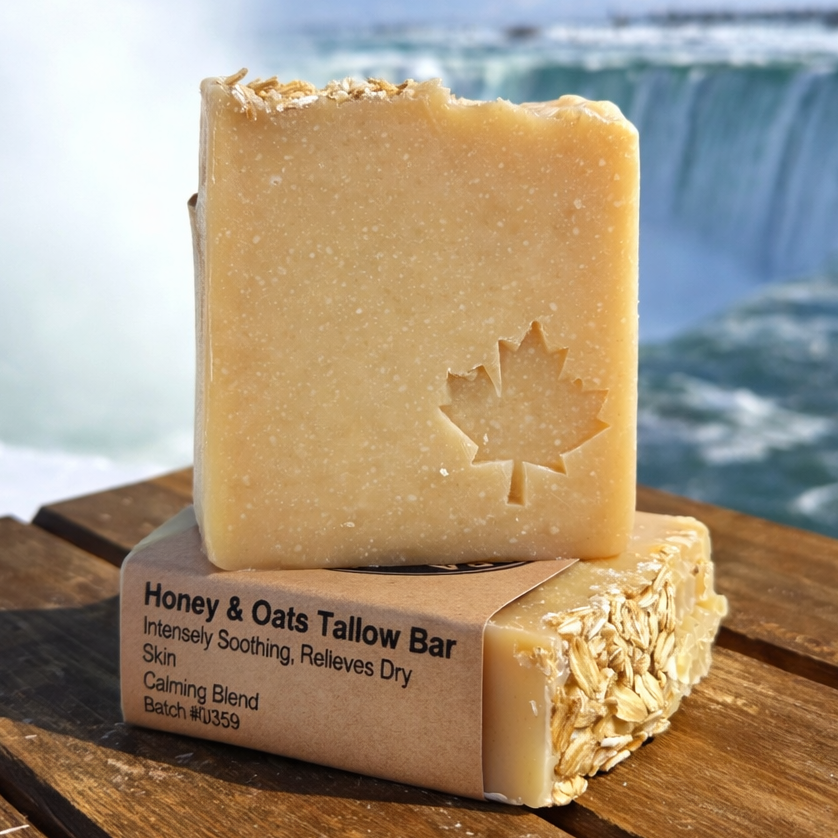 Bar of soap with a maple leaf design on a wooden surface in front of Niagara Falls.