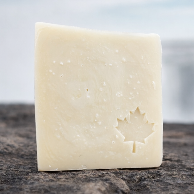 Bar of soap on a rock with a blurred natural background