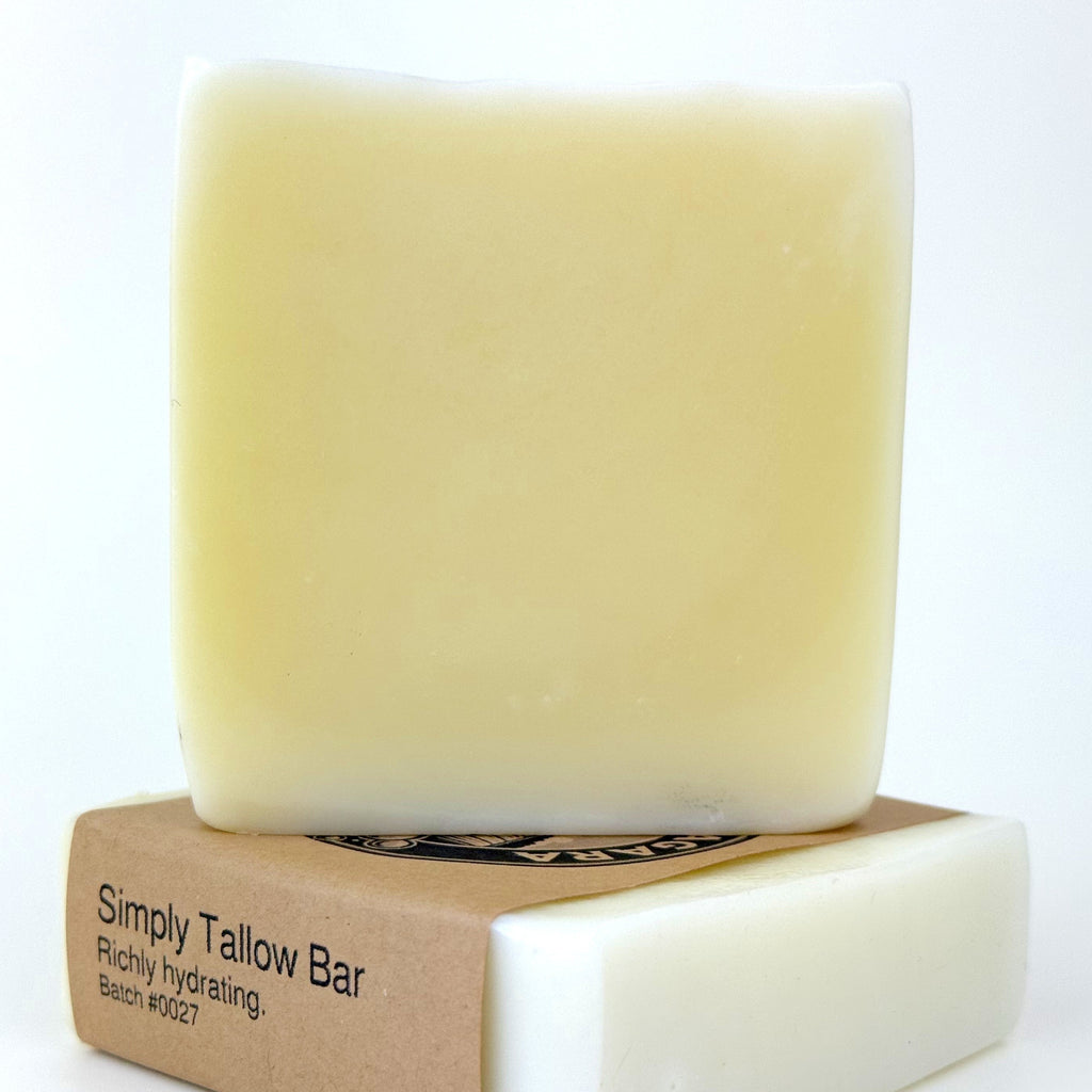 Bar of tallow soap with a cardboard label on a white background