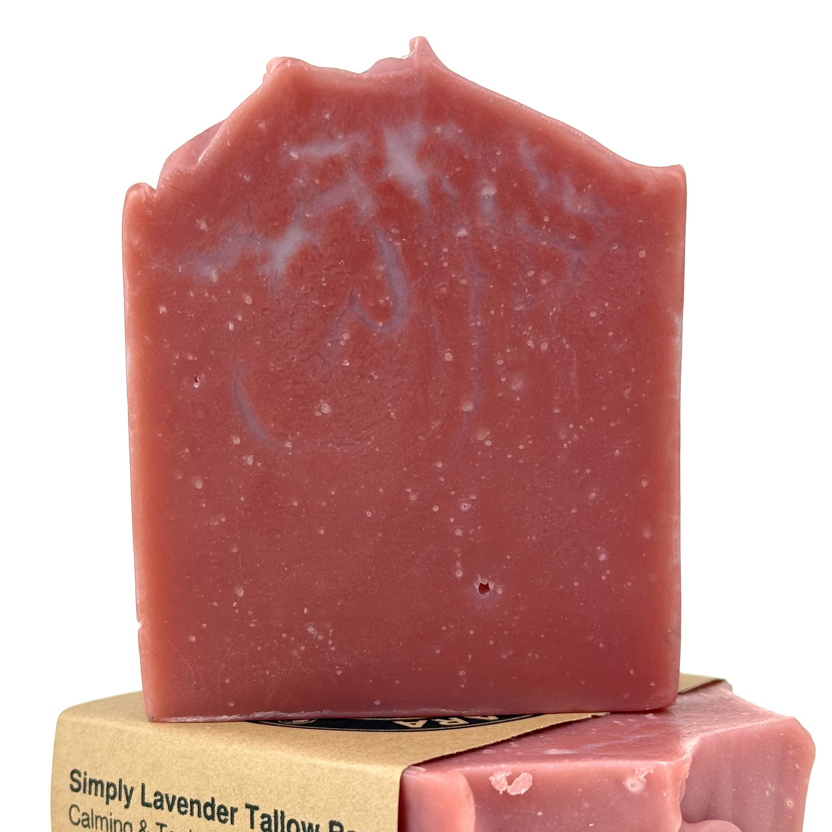 Red soap bar with a cardboard wrapper on a white background