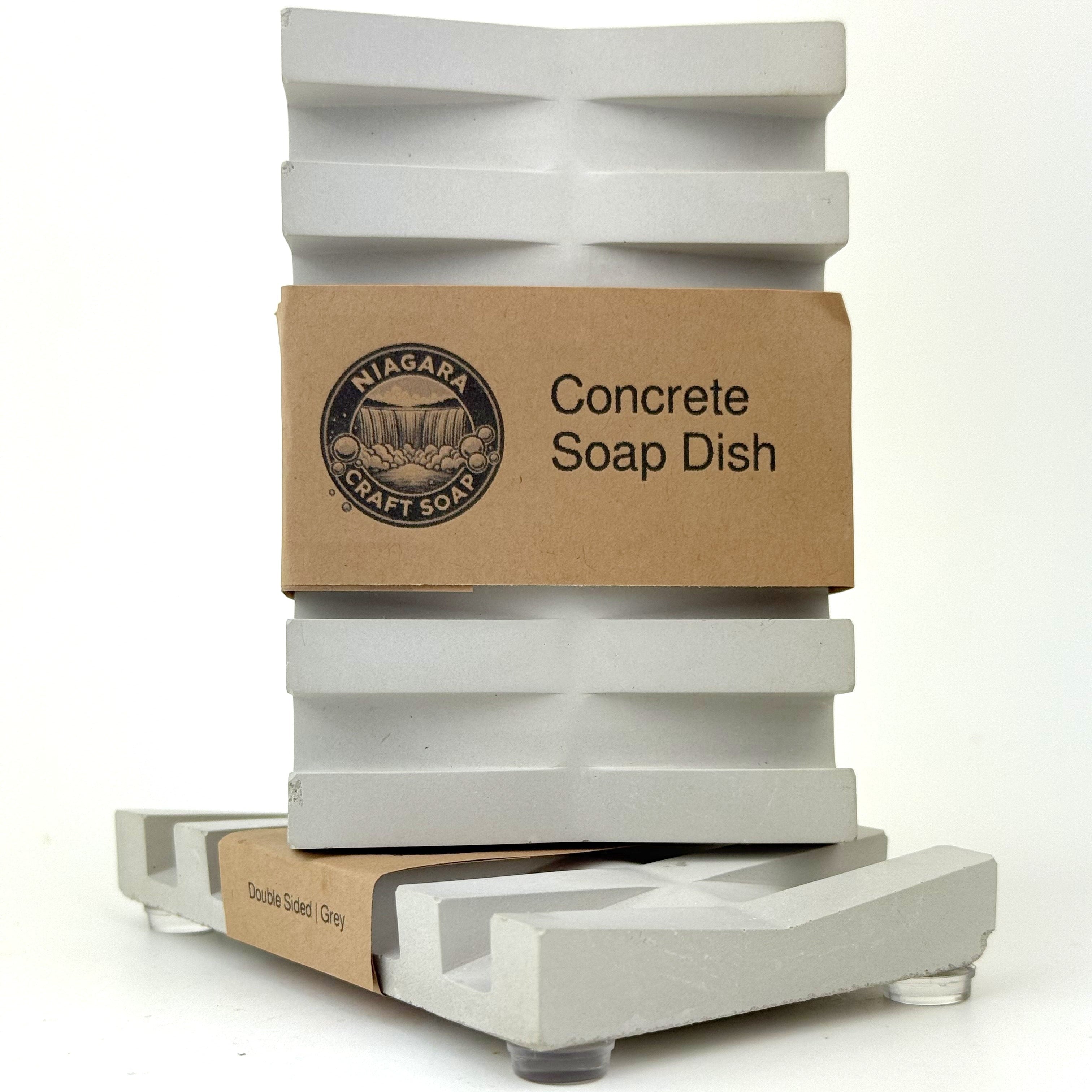 Concrete soap dish with thin craft paper wrapping on a white background