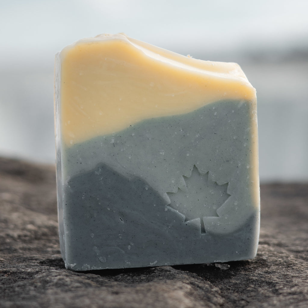 Niagara Craft Soap bar soap Niagara Mist Aloe Bar stamped with a maple leaf  pattern standing on stone in front of a blurry Niagara Falls Photographer Kurt Casucci